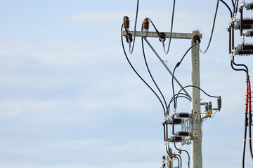 An electrical pole with a transformer installed for distributing electricity.