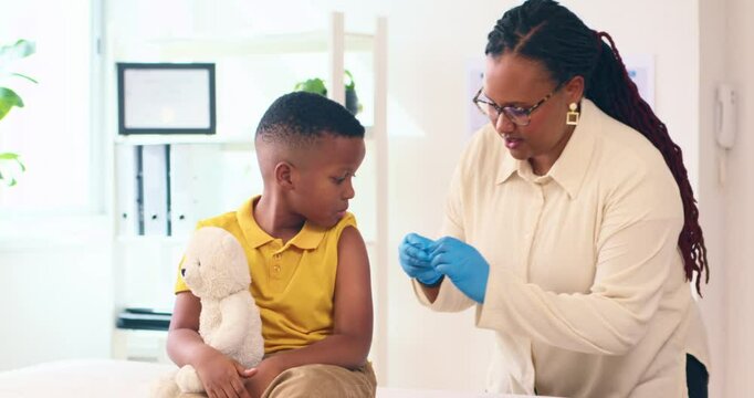 Pediatrician Placing Bandage After Vaccine