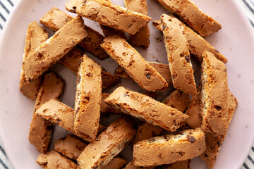 Homemade Cantuccini Cookies with Chocolate Chips on a Plate, top view. Close-up.