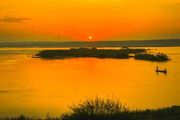 Beautiful sunrise on River Nile with a fishing boat at Murchison Falls National Park in Uganda