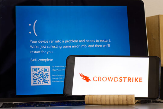 CrowdStrike logo and blue computer screen during mass tech outages worldwide have caused IT systems to shut down, Microsoft system error caused by CrowdStrike.