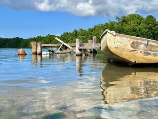 peaceful seascape of Guadeloupe in the French West Indies with a view of an old white boat with an...