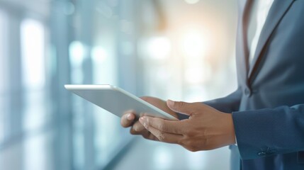 Businessman using tablet in modern office environment. Professional work concept with technology and innovation.