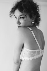 The back of a beautiful slender athletic girl in a bra, a woman in beautiful lingerie, beautiful female hands
