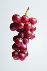 Red Globe Grape levitating on a white background