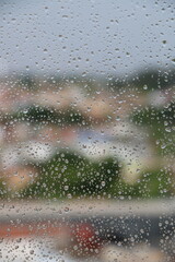 Raindrops on Window with City Lights at Night