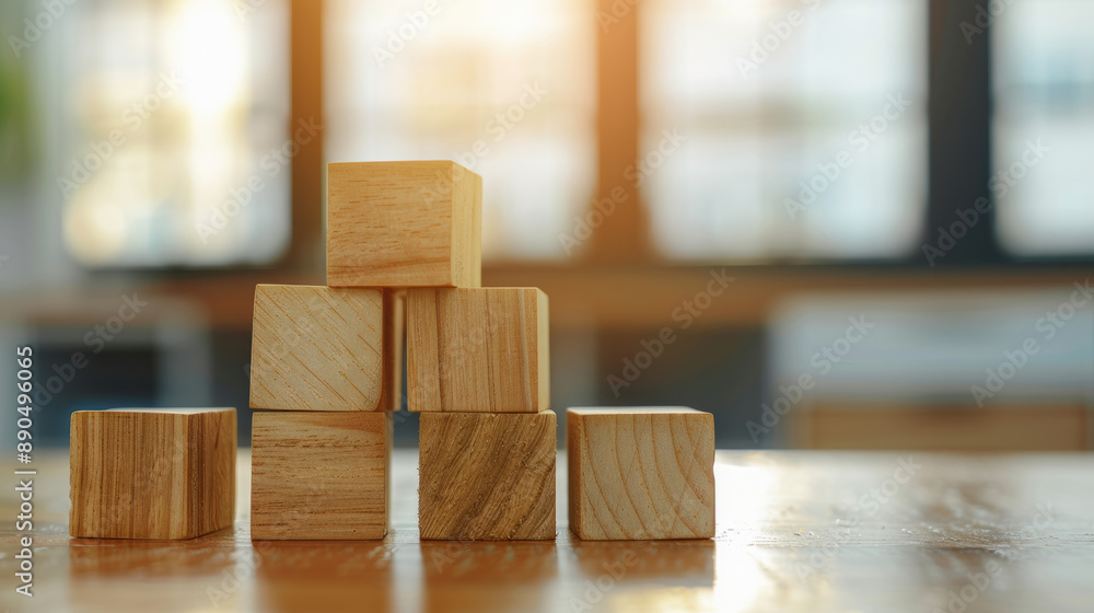 Poster stacked wooden blocks on a shiny table with sunlight streaming through windows. concept of balance, 