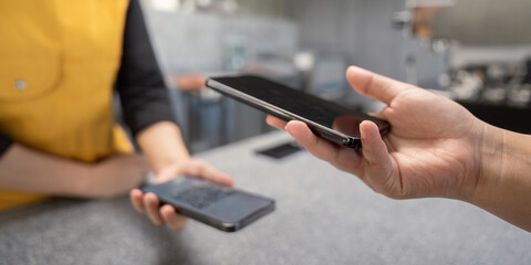 Contactless Payment Transaction at a Modern Retail Store with Smartphone Technology
