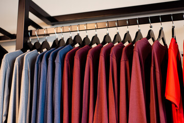 Colorful long sleeve running shirts on clothing rack hanger at outdoor store in Southlake, Texas,...