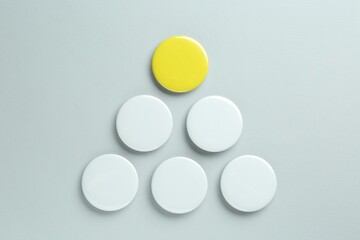 Blank button badges on light background, flat lay. Mockup for design