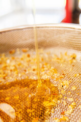 Viscouse Sweet Bee Honey Running Down Into the Sieve Net Extreme Close Up