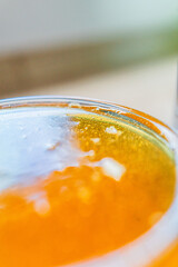 Golden Bee Honey Freshly Filled in a Honey Jar Extreme Close Up