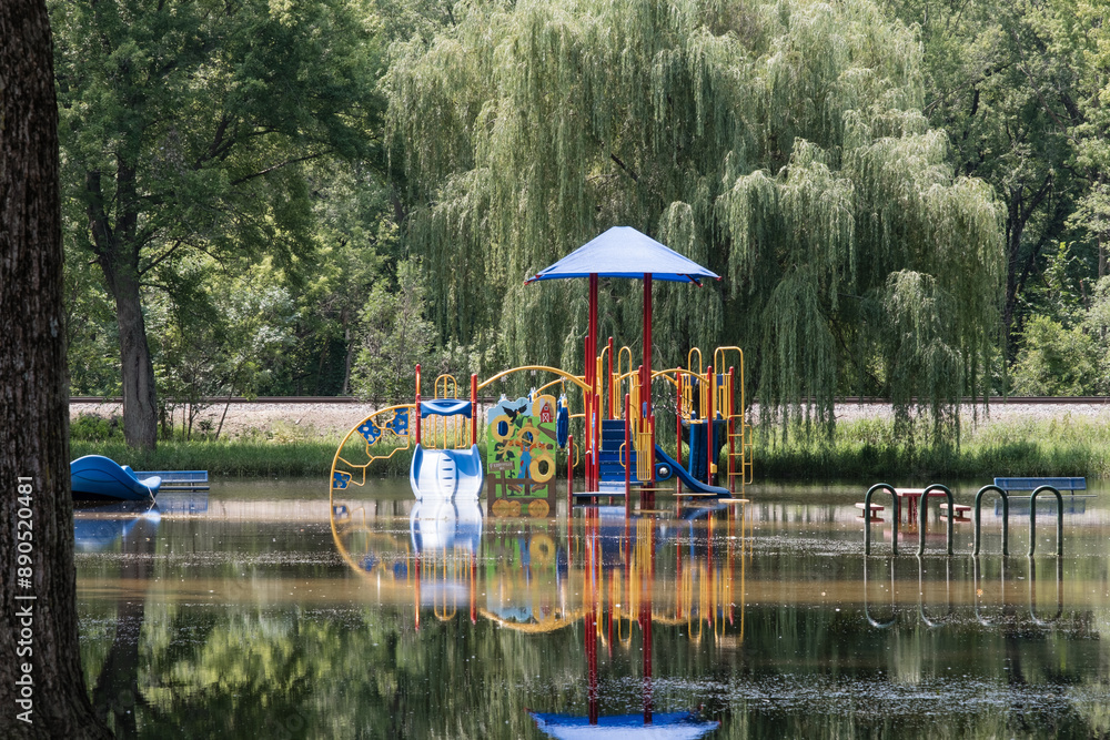 Wall mural flooded playground with colorful equipment in a country setting