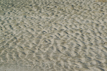 Texture and background of wrinkles, waves sand on a beach.