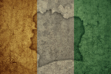 map and flag of cote divoire on a old vintage crack paper background .