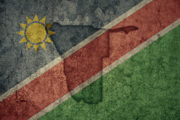 map and flag of namibia on a old vintage crack paper background .