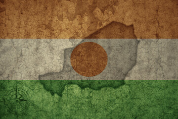 map and flag of niger on a old vintage crack paper background .