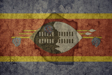 map and flag of eswatini on a old vintage crack paper background .
