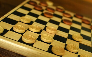 wooden checkers on a chessboard