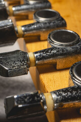 Close up from a Headstock  of a guitar made of Maple wood, and some silver color tuners. 