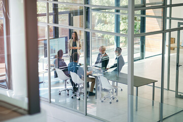Business woman, presentation and conference room window with collaboration and digital chart....