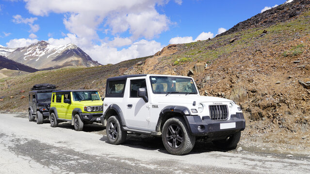 Vehicles parked on the road side of jispa village : Manali, Rohtang pass, India, India- 15 July &lrm;2024