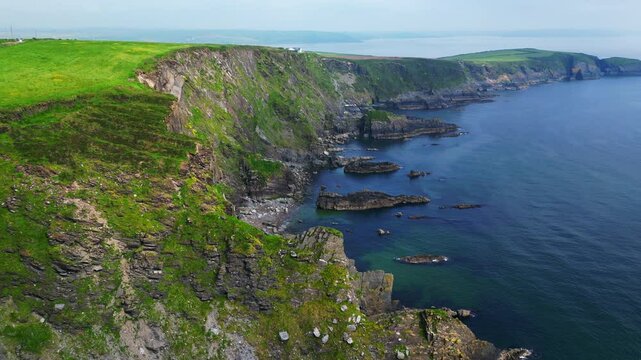 A view of Ireland from the air and a UAV Drone looking at Old Head near Kinsale where there is a famous lighthouse and golf course with Ocean Cliffs