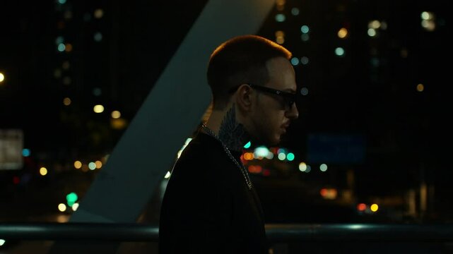 cool guy walking in the night, citylights in background