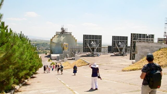 Parkent, Uzbekistan - 10th november, 2023: tourist group visit famous rare unique soviets The solar furnace of Uzbekistan. Parabolic reflector. Institute of the sun and Physics of sun