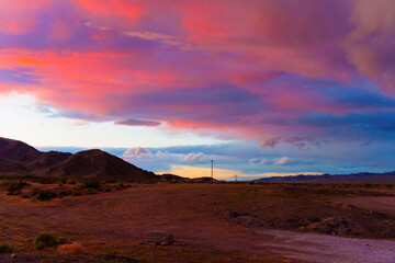 Californian Desert Sunset with Heavy Vibrant Clouds over the Rugged Terrains
