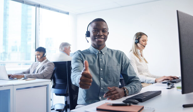Thumbs up, call center and portrait of black man in office for insurance technical support or telemarketing. Smile, ecommerce and African consultant with approval hand gesture for customer service.