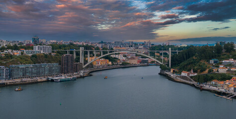 Obraz premium Aerial view of the European city Porto with Luis I Bridge over Douro river in Portugal, aerial view. Panoramic aerial view of Dom Luis Bridge in Porto