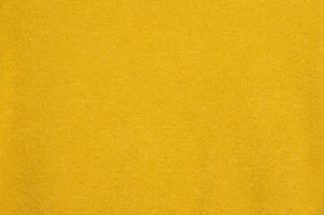 Naklejka premium Yellow knitted fabric background and texture.