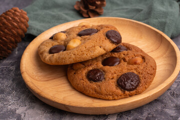 chocolate macadamia soft cookies on a table and plate