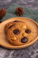 chocolate macadamia soft cookies on a table and plate