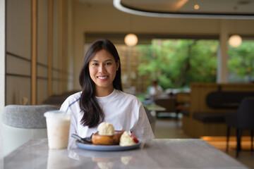 Young Thai Woman Enjoying Dessert at Coffee Shop