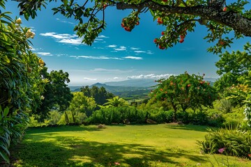 Obraz premium Lush green lawn with vibrant red flowers and mountains in the distance.