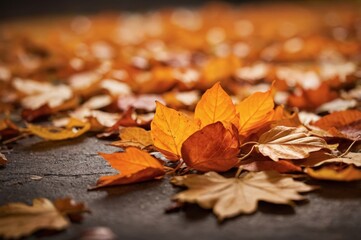 Golden autumn leaves scattered on dark surface