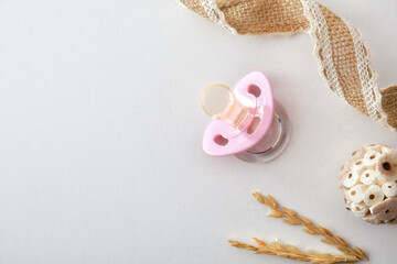 Female baby background with pink pacifier and decoration isolated white