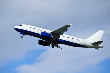Airplane in flight. Travel background with airplane flying in the blue sky