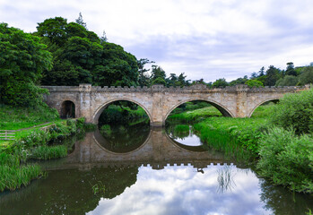 Fototapeta premium Alnwick, Northumberland, UK, June 18, 2024; aerial view of Lion Bridge, Alnwick, Northumberland, England, UK.