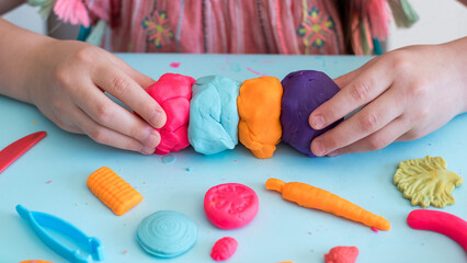 Colorful clay. Child's hands playing with colorful clay. Plasticine. play dough.