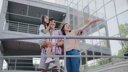 A joyful urban family bonds outdoors among modern architecture, creating lasting memories and expressing love, enjoying quality time together and fostering relationships