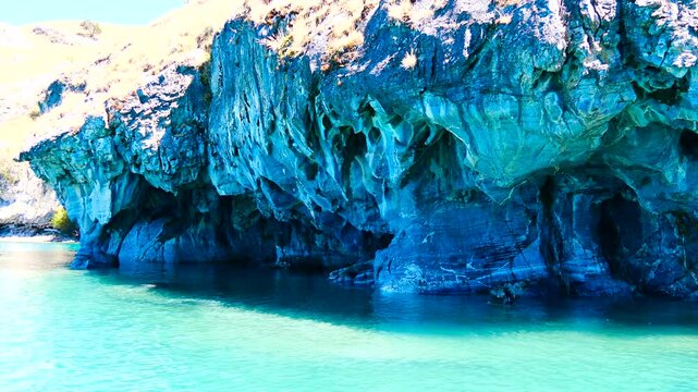 Slowly drifting passed the Turquoise water and blue marble caves Cuevas de M&aacute;rmol.