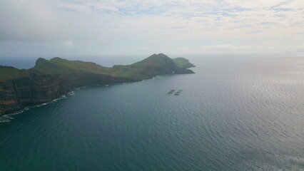 Drone tranquil sea bay on cloudy morning. Panoramic scenery of ocean island