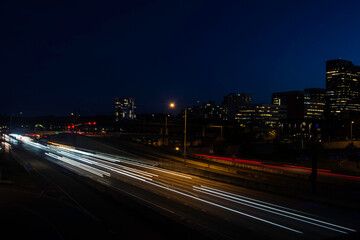 Oncoming freeway downtown traffic time lapse at night