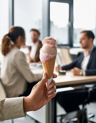 Female Hand holding ice cream cone in busy Office | deserved break, ready for vacation, celebrating success
