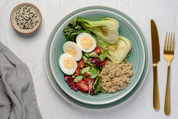 Food photography of breakfast with boiled egg and quinoa, salad, vegetables, fiber, balanced, cucumber; bok choi; sesame, seed, paleo, diet; brunch; meal; food; cook; cuisine; nutrition