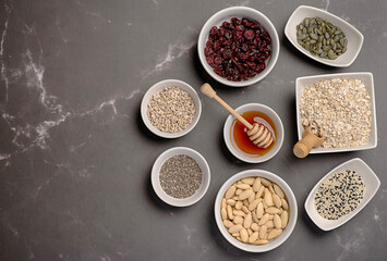 Blank photography of raw granola ingredients, almond, oat, flake, chia, seed, sesame, pumpkin, sunflower, honey, agave, syrup, dried, cranberries, recipe, crunchy