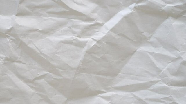 Abstract grunge crumpled paper background. Old wrinkled creased paper texture background. Stop motion. 4K